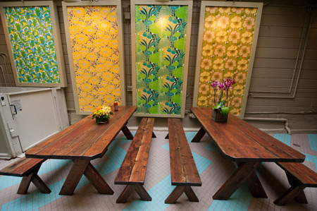 The back patio at Glaze is enlivened with panels of vintage wallpaper.