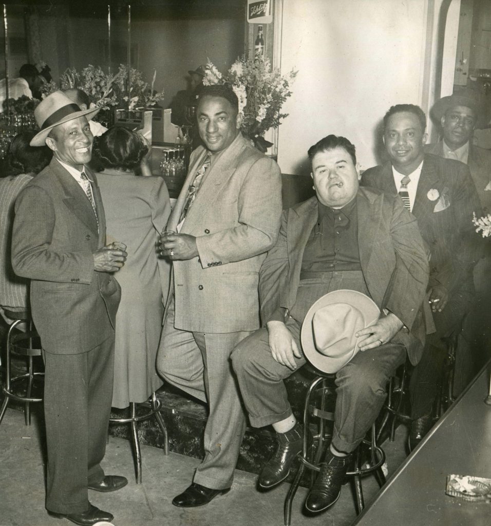 Charles Sullivan (center left, with Fats Corlett sitting beside him) in the Booker T. Washington Hotel at Fillmore and Ellis.