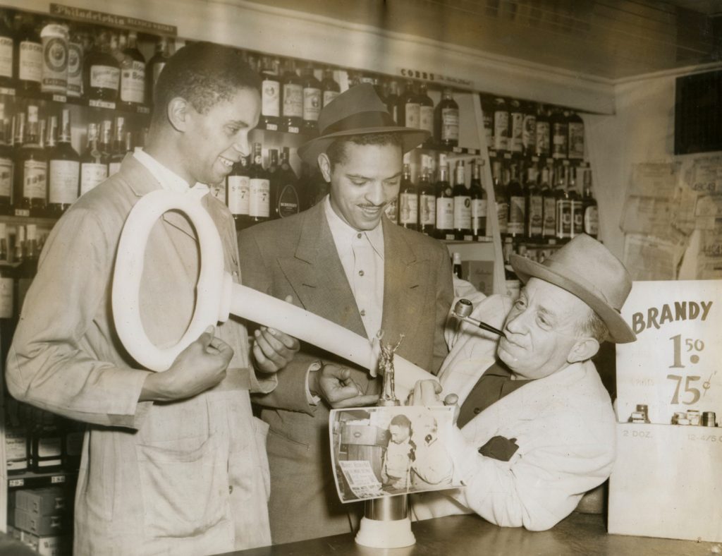 Charles Sullivan also owned the Post Street Liquor Co., which was run by his brother-in-law George Hall (center, with Sullivan’s key to the city). Photograph courtesy of the Hall family.